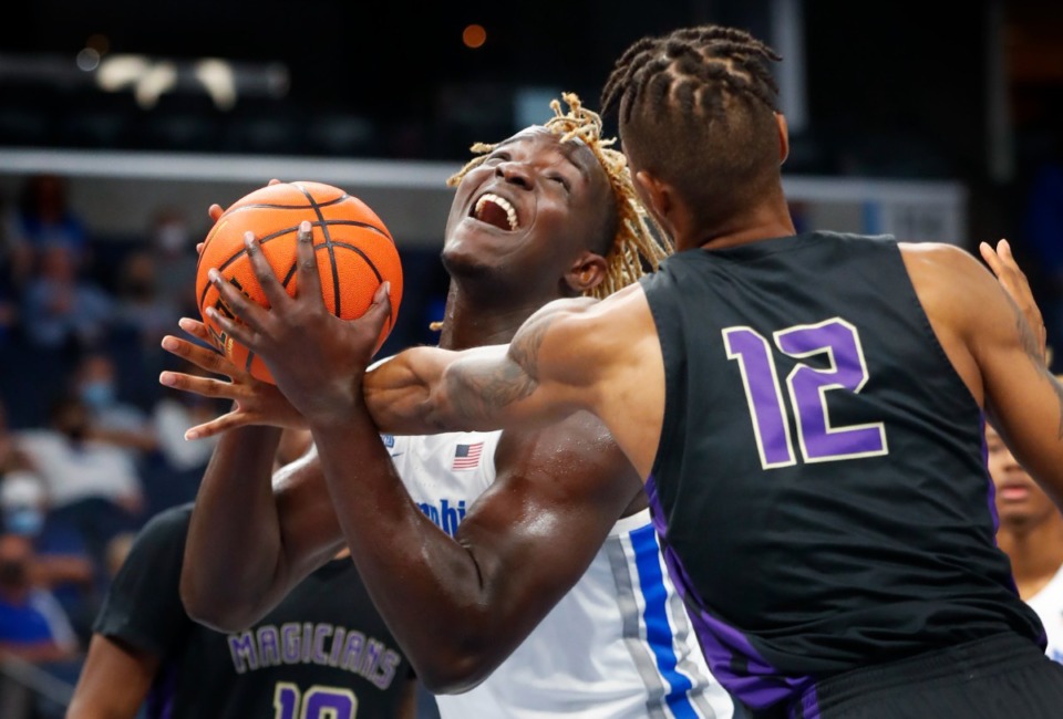 <strong>Tigers center Sam Onu (left) is fouled during action against LeMoyne-Owen College on Sunday, Oct. 24, 2021.</strong> (Mark Weber/The Daily Memphian)
