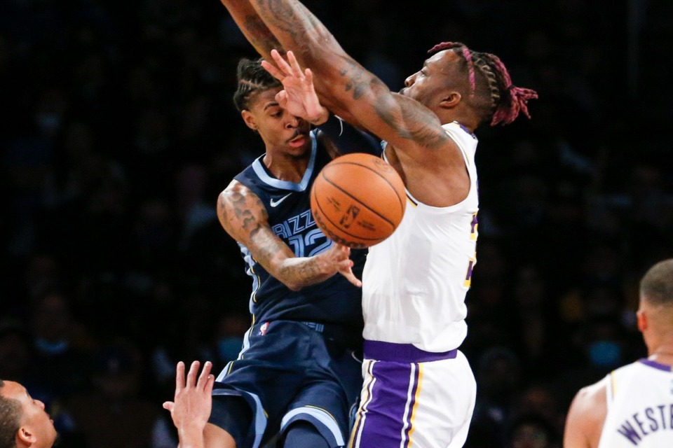 <strong>Memphis Grizzlies guard Ja Morant, left, passes the ball while defended by Los Angeles Lakers center Dwight Howard (39) during the second half of an NBA basketball game in Los Angeles, Sunday, Oct. 24, 2021. The Lakers won 121-118.</strong> (AP Photo/Ringo H.W. Chiu)