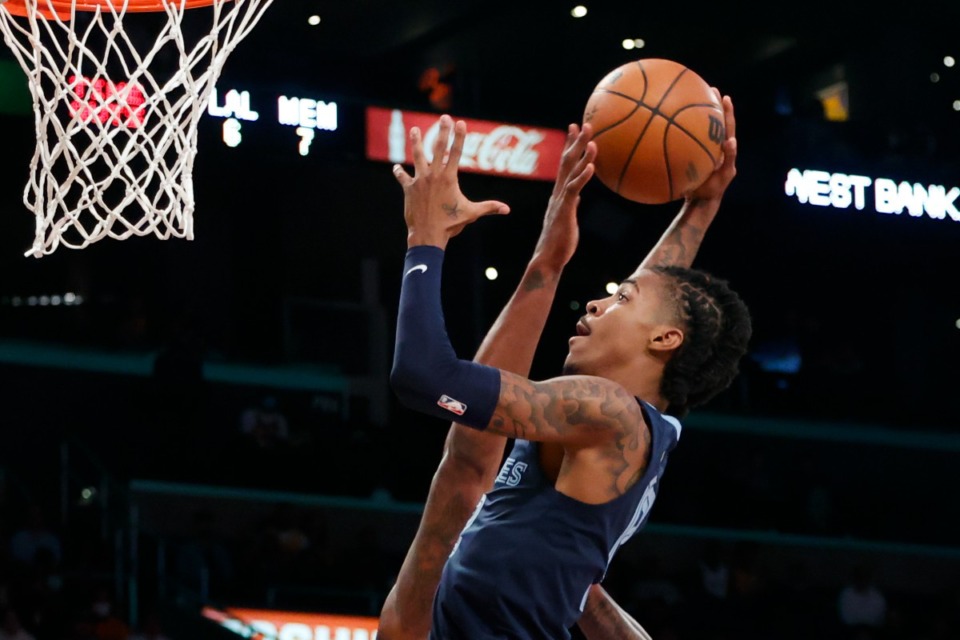 <strong>Memphis Grizzlies guard Ja Morant (12) goes to the basket under pressure from Los Angeles Lakers center DeAndre Jordan (10) during the first half of an NBA basketball game in Los Angeles, Sunday, Oct. 24, 2021.</strong> (AP Photo/Ringo H.W. Chiu)