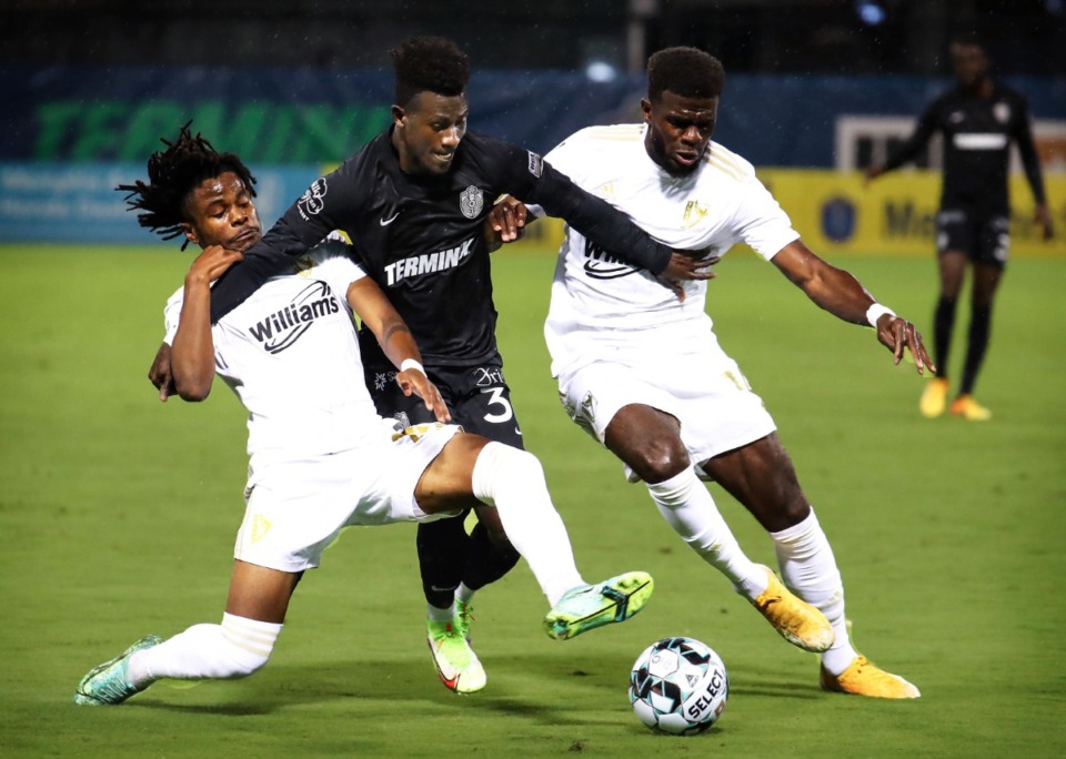 <strong>Memphis 901 FC midfielder Laurent Kissiedou (30) fights off two defenders during the Oct. 27, 2021, match against FC Tulsa.</strong> (Patrick Lantrip/Daily Memphian)