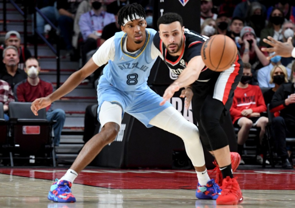 <strong>Portland Trail Blazers forward Larry Nance Jr., right, pokes the ball away from Memphis Grizzlies guard Ziaire Williams, left, on Oct. 27 in Portland.</strong> (Steve Dykes/AP)