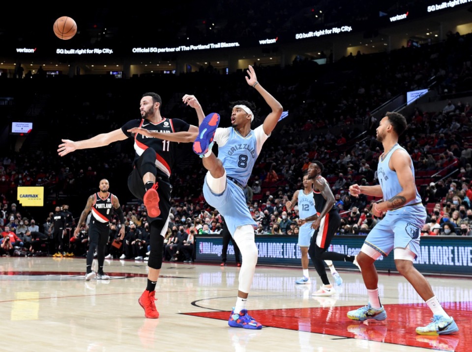 <strong>Trail Blazers forward Larry Nance Jr., left, and Grizzlies guard Ziaire Williams, right, go after a rebound on Oct. 27 in Portland.</strong> (Steve Dykes/AP)