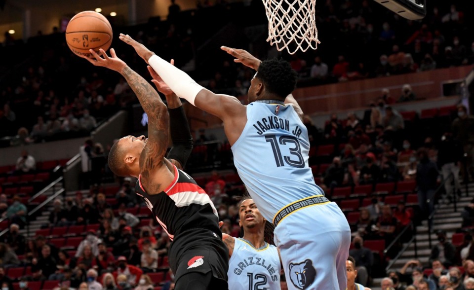 <strong>Trail Blazers guard Damian Lillard, left, drives to the basket against Grizzlies forward Jaren Jackson Jr., right, on Oct. 27 in Portland.</strong> (Steve Dykes/AP)