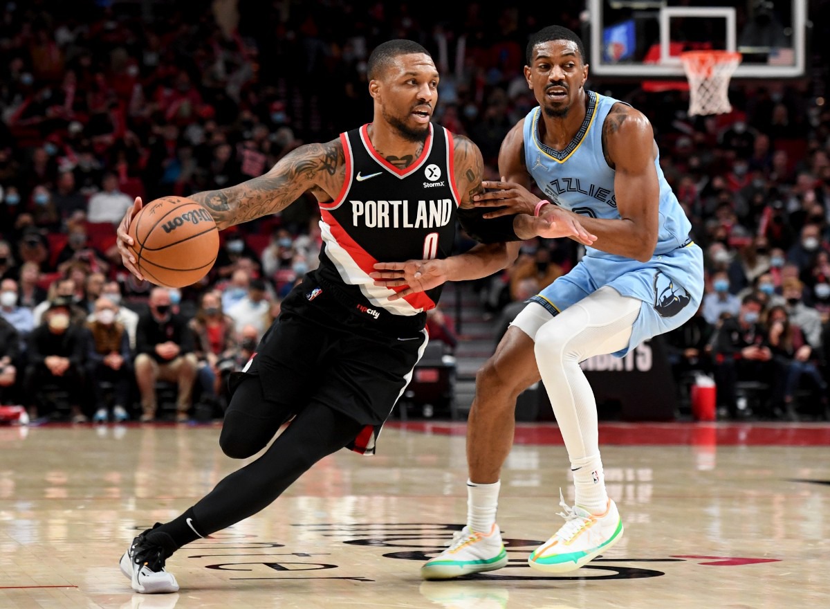 <strong>Trail Blazers guard Damian Lillard, left, drives to the basket against Grizzlies guard De'Anthony Melton, right,&nbsp;on Oct. 27 in Portland.</strong> (Steve Dykes/AP)