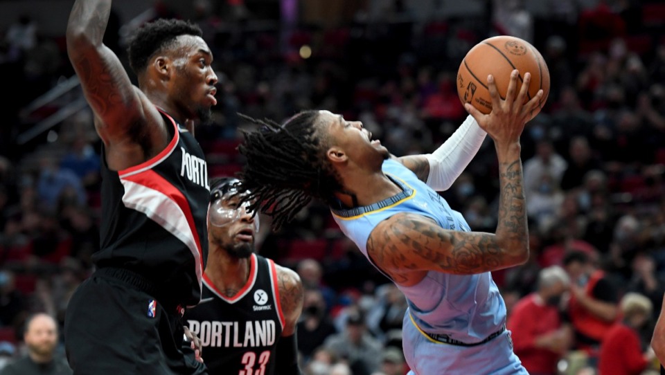 <strong>Memphis Grizzlies guard Ja Morant drives to the basket on Portland Trail Blazers forward Nassir Little (left) during their game in Portland, Ore., Wednesday, Oct. 27. The Grizzlies lost, 116-96.</strong> (Steve Dykes/Associated Press)