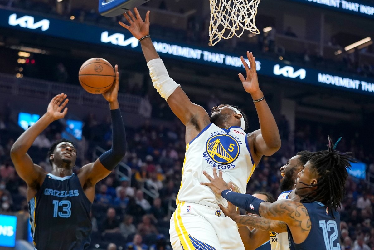 <strong>Grizzlies forward Jaren Jackson Jr. (13) grabs a rebound behind Golden State Warriors center Kevon Looney (5) on Oct. 28 in San Francisco.</strong> (Jeff Chiu/AP)