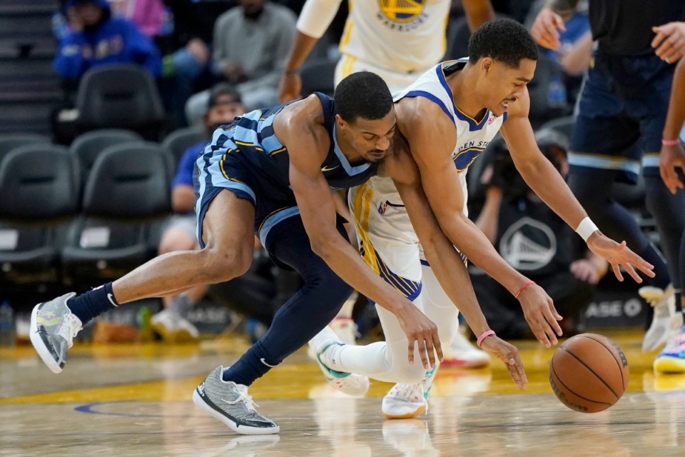 <strong>Grizzlies guard De'Anthony Melton, left, and Golden State Warriors guard Jordan Poole reach for the ball</strong>&nbsp;<strong>in San Francisco on Oct. 28.</strong> (Jeff Chiu/AP)