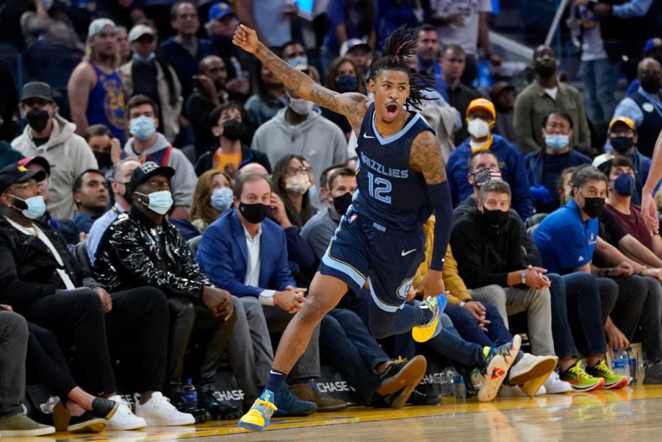 <strong>Grizzlies guard Ja Morant celebrates after the Grizzlies defeat the Golden State Warriors in overtime in San Francisco on Oct. 28.</strong> (Jeff Chiu/AP)