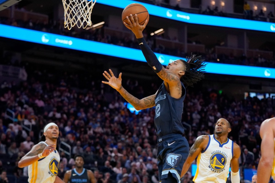 <strong>Grizzlies guard Ja Morant, middle, shoots in front of Golden State Warriors guard Damion Lee, left, and forward Andre Iguodala (9) during overtime</strong>&nbsp;<strong>in San Francisco on Oct. 28.</strong> (Jeff Chiu/AP)