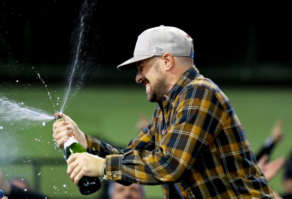 <strong>Memphis 901 FC fans celebrate with champagne after the team's last regular season match Oct. 30, 2021 against Indy Eleven.</strong> (Patrick Lantrip/Daily Memphian)