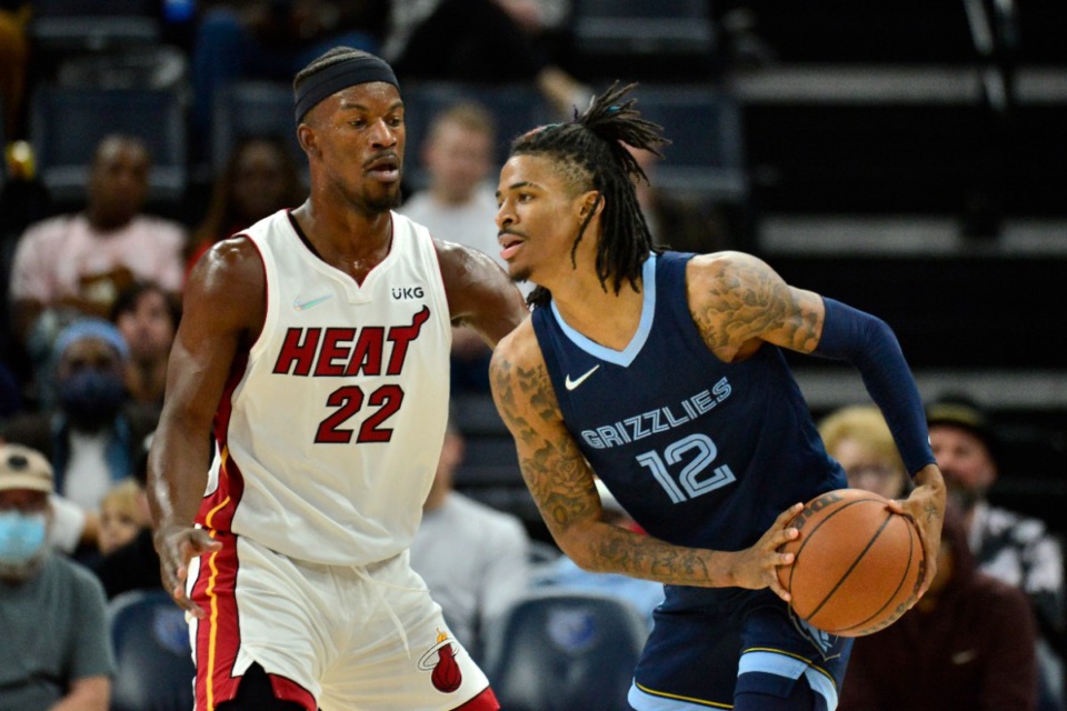 <strong>Memphis Grizzlies guard Ja Morant (12) is defended by Miami Heat forward Jimmy Butler (22) during the first half of an NBA basketball game Saturday, Oct. 30, 2021, at FedExForum.</strong> (AP Photo/Brandon Dill)