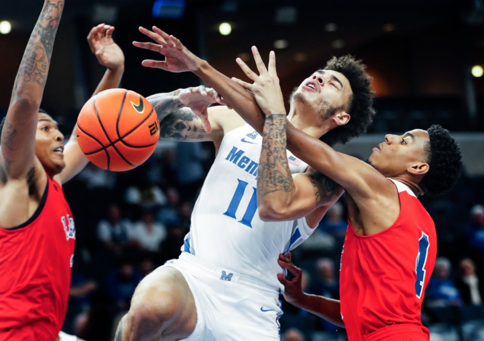 <strong>Memphis Tigers guard Lester Quinones (middle) loses the ball while driving the lane against Lane College defenders Anthony Mason (left) and Chancellor Wright (right) during action on Sunday, Oct. 31, 2021 at FedExForum.</strong> (Mark Weber/The Daily Memphian)