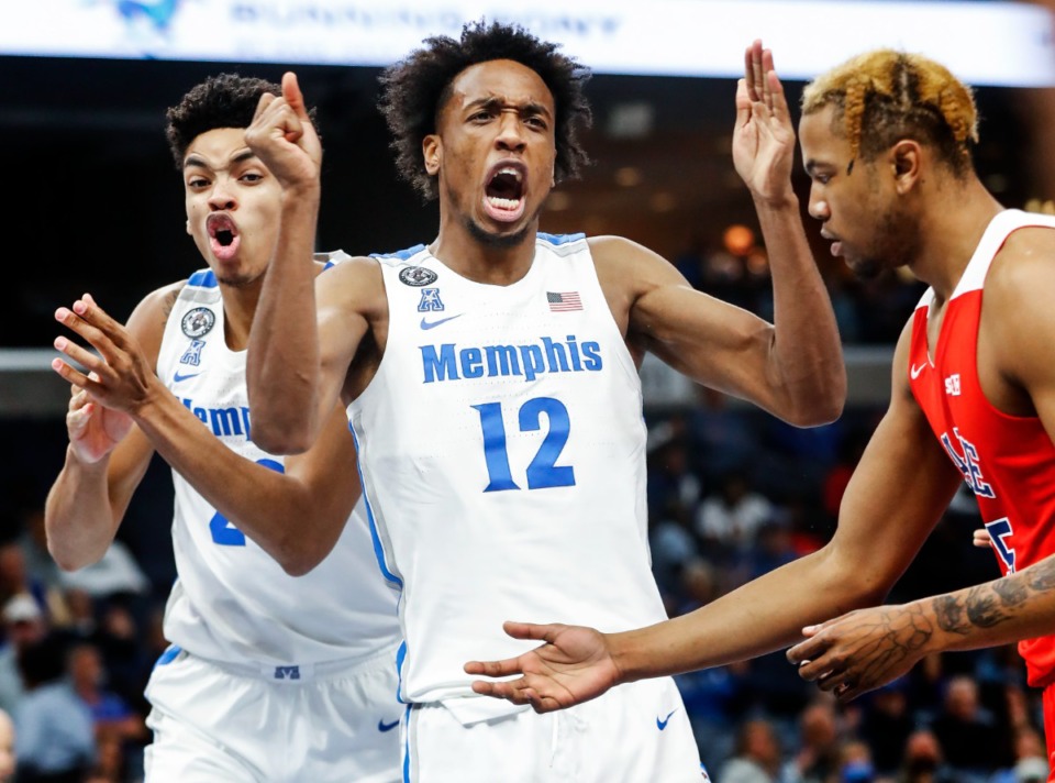 <strong>Memphis Tigers teammates Josh Minott (left) and DeAndre Williams (middle) celebrate during action Sunday, Oct. 31, 2021 at FedExForum. At right is Lane College player Justin Sylver.</strong> (Mark Weber/The Daily Memphian)