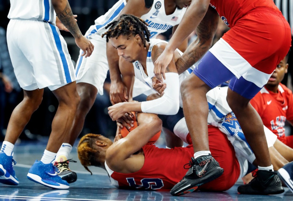 <strong>Memphis Tigers guard Emoni Bates (middle) battles Lane College freshman Justin Sylver (35) for a loose ball during action on Sunday, Oct. 31, 2021 at FedExForum.</strong> (Mark Weber/The Daily Memphian)