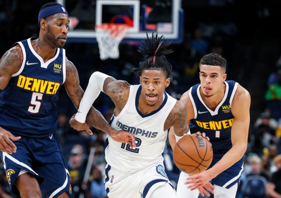 <strong>Memphis Grizzlies guard Ja Morant (middle) drives past Denver Nuggets defenders Will Barton (left) and Michael Porter Jr. during action on Monday, Nov. 1.</strong> (Mark Weber/Daily Memphian)