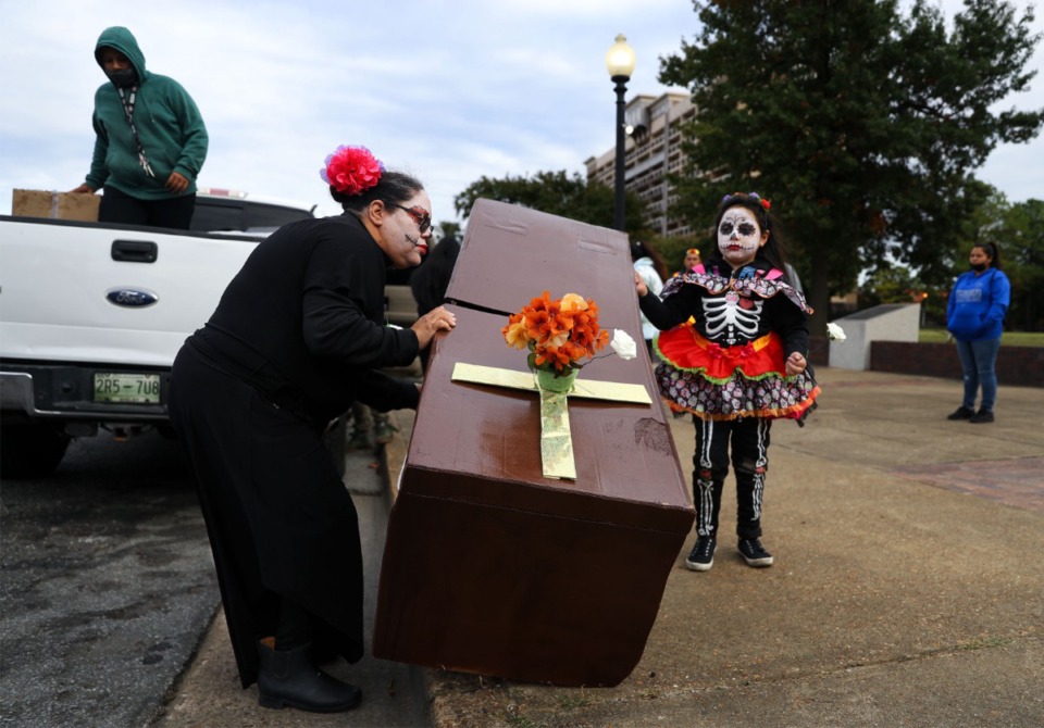 <strong>Karina Salcedo unloads a cardboard&nbsp; coffin with the help of her daughter, Darily Cerna, outside Church Park on Tuesday, Nov. 2.</strong> (Patrick Lantrip/Daily Memphian)