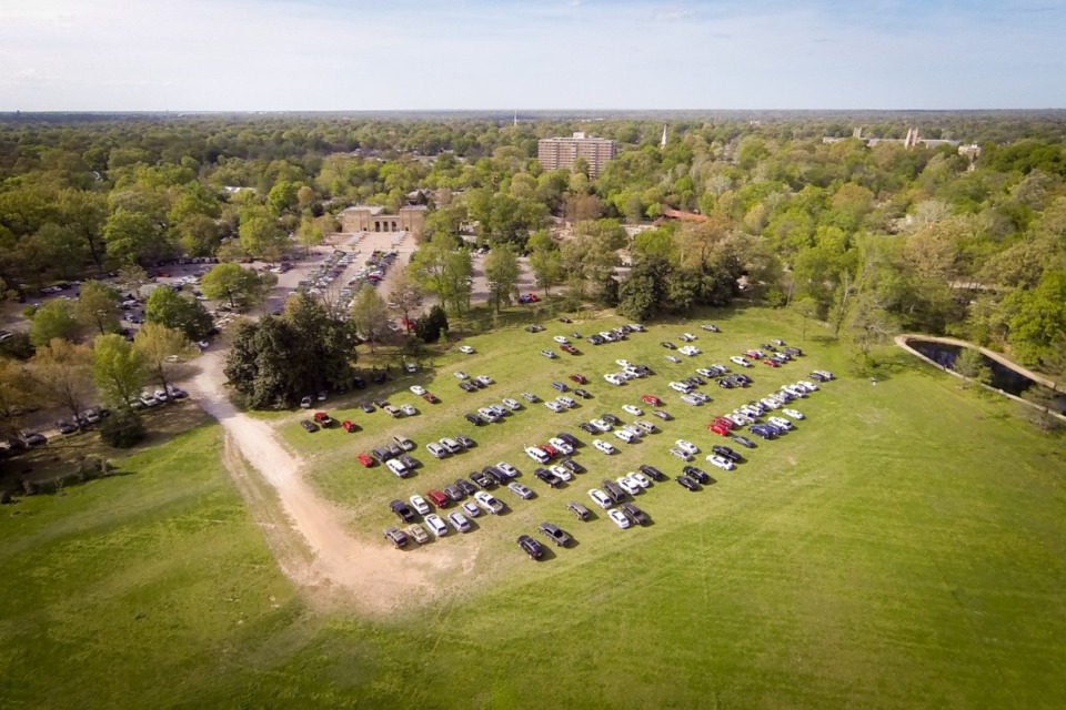 <strong>An overhead view in 2015 shows the cars of Memphis Zoo patrons parked on the Overton Park greensward. Plans to expand the Zoo parking lot into the greensward are again on hold.</strong> (Daily Memphian file)