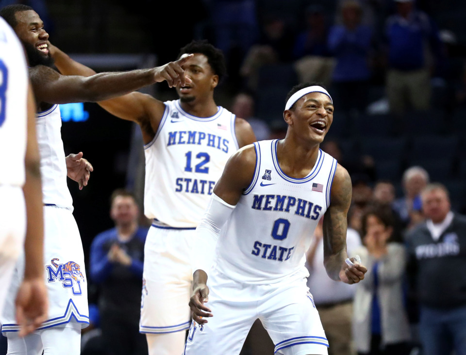 <strong>Memphis Tigers forward Kyvon Davenport (0) celebrates after guard Jeremiah Martin (3) breaks his own record by scoring 43 points in a single game during a matchup against Tulane on Wednesday, Feb. 20, 2019, in Memphis.</strong>&nbsp; &nbsp;(Houston Cofield/Daily Memphian)