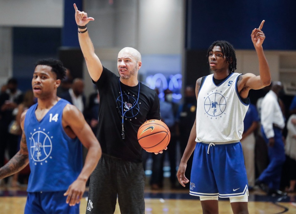 <strong>Tigers assistant coach Cody Toppert (middle) works with players including Tyler Harris (left) and Johnathan Lawson on the first day of practice on Tuesday, Sept. 28, 2021.</strong> (Mark Weber/The Daily Memphian)