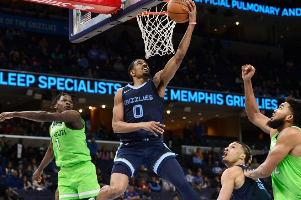 <strong>Grizzlies guard De'Anthony Melton (0) shoots despite Minnesota Timberwolves forward Anthony Edwards (1) in overtime on Nov. 8 at FedExForum.</strong> (Brandon Dill/AP file)