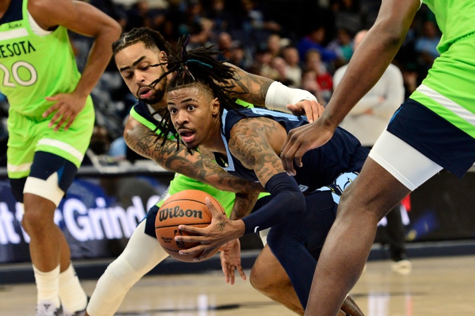 <strong>Grizzlies guard Ja Morant drives past Minnesota Timberwolves guard D'Angelo Russell on Nov. 8 at FedExForum.</strong> (Brandon Dill/AP file)
