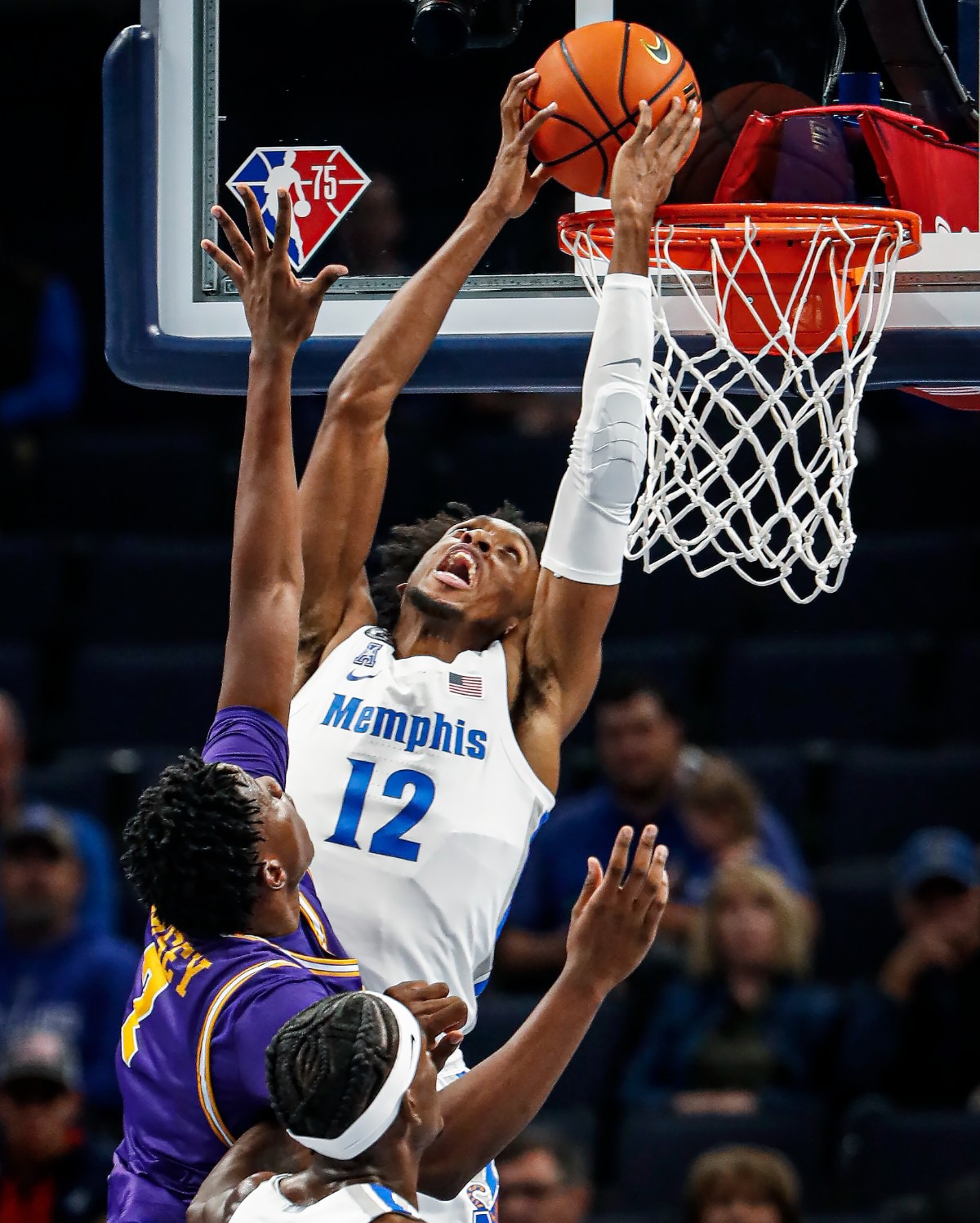 <strong>Tigers forward DeAndre Williams (top) completes a reverse dunk against Tennessee Tech on Tuesday, Nov. 9, 2021.</strong> (Mark Weber/The Daily Memphian)