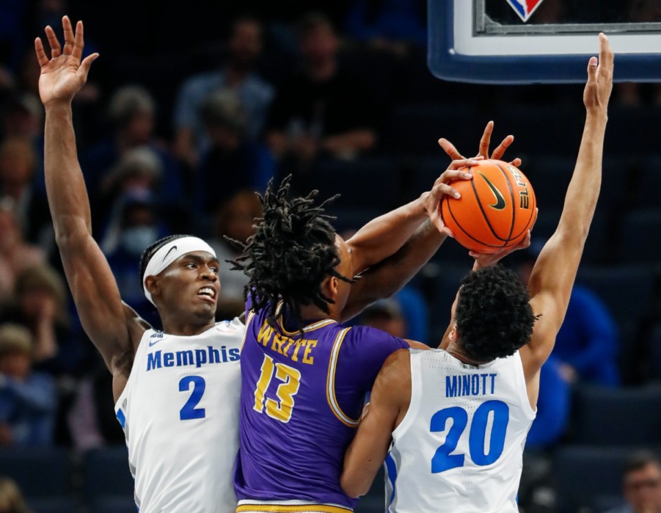 <strong>Tigers teammates Jalen Duren (left) and Josh Minott (right) apply defensive pressure to Tennessee Tech forward Kenny White Jr. (middle) on Tuesday, Nov. 9, 2021.</strong> (Mark Weber/The Daily Memphian)