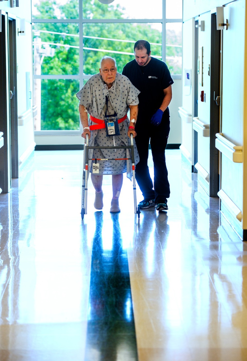 <strong>Manaf Baddar, PTA walks patient Charles Nichols to keep his strength during his stay at Saint Francis Hospital-Bartlett, Friday, May 24, 2019.</strong> (Greg Campbell/Special to The Daily Memphian)