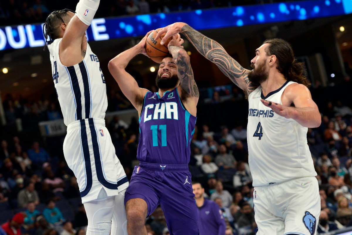 <strong>Charlotte Hornets forward Cody Martin (11) shoots between Grizzlies center Steven Adams (4) and forward Dillon Brooks&nbsp;on Nov. 10 at FedExForum.</strong> (Brandon Dill/AP)