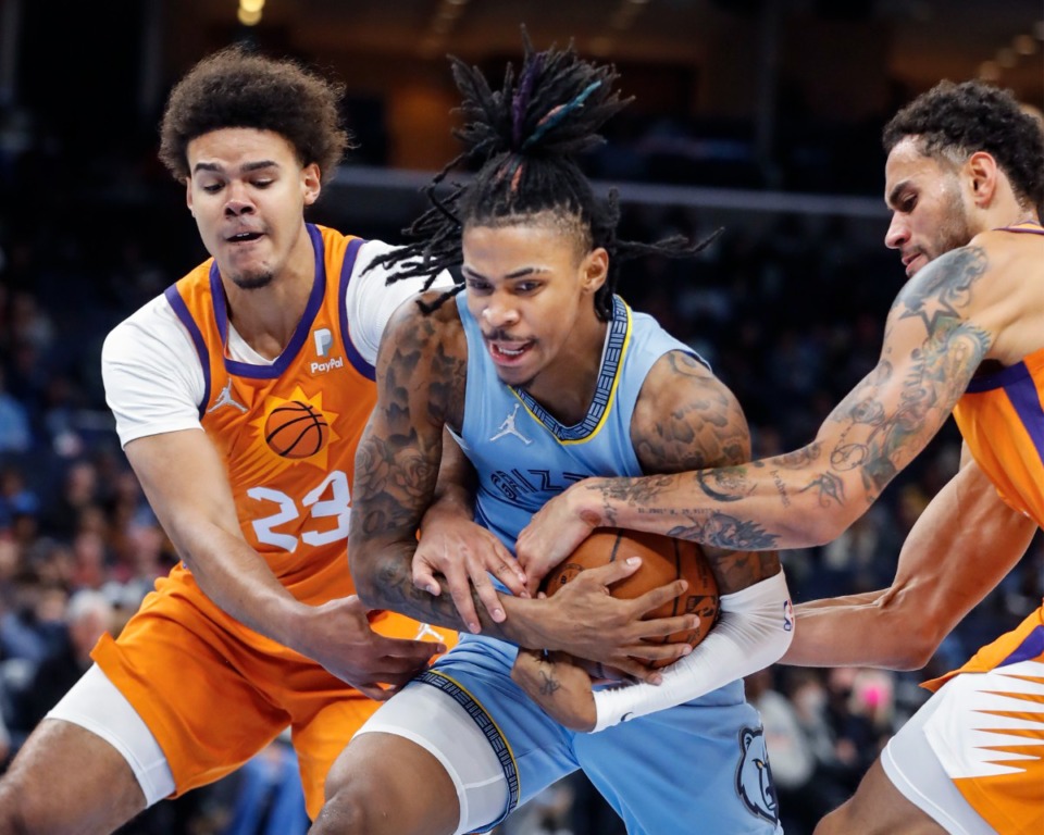 <strong>Grizzlies guard Ja Morant (middle) drives the lane against Phoenix Suns defenders Cameron Johnson (left) and Abdel Nader (right) on Friday, Nov. 12, 2021.</strong> (Mark Weber/The Daily Memphian)