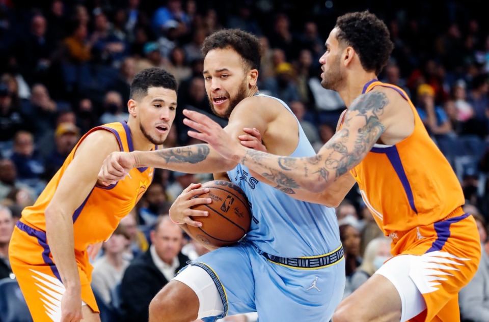 <strong>Grizzlies forward Kyle Anderson (middle) drives the lane against Phoenix Suns defenders Devin Booker (left) and Abdel Nader (right) on Friday, Nov. 12, 2021.</strong> (Mark Weber/The Daily Memphian)