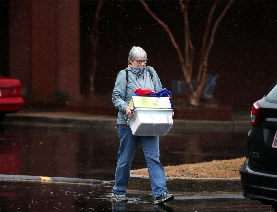 <strong>Laura McManus hurries to the car with a stack of purchases after shopping at the Bartlett Towne Center. Capital investment broke records in 2018 for the Bartlett area, reaching $165 million thanks to a number of large projects and a spike in retail.</strong> (Houston Cofield/Daily Memphian)