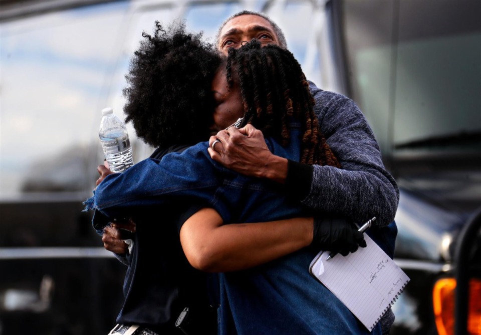 <strong>A Memphis police officer hugs the family of rapper Young Dolph after he was killed outside of a store on Airways Boulevard on Nov. 17, 2021.</strong> (Patrick Lantrip/Daily Memphian)
