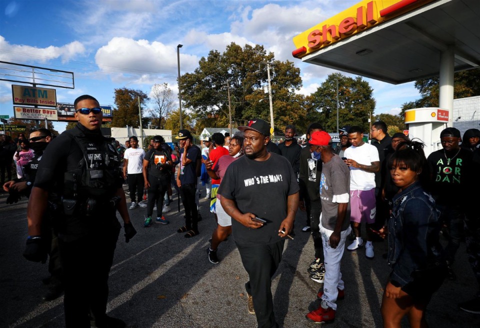<strong>Memphis police officers work the crowd at the scene where rapper Young Dolph was killed outside of a storeon Airways Boulevard on Nov. 17, 2021.</strong>(Patrick Lantrip/Daily Memphian)