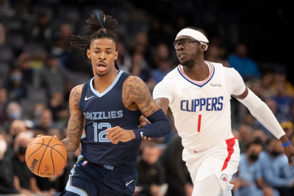 <strong>Grizzlies guard Ja Morant (12) drives the lane with Los Angeles Clippers guard Reggie Jackson (1) in pursuit on Nov. 18, 2021, at FedExForum.</strong> (Nikki Boertman/AP)