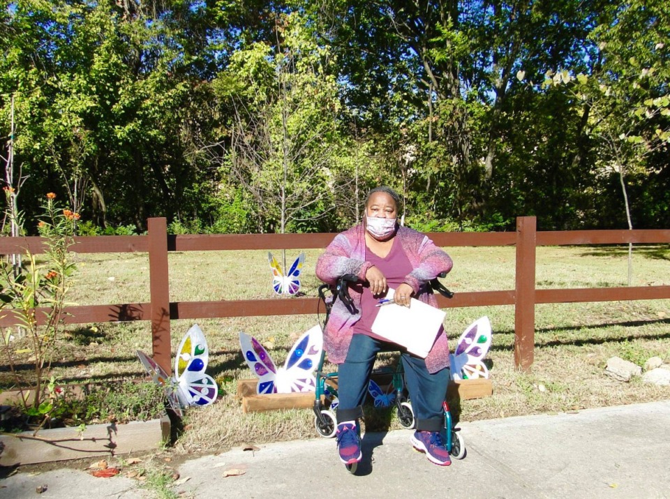 <strong>Quincey Morris, executive director of the Klondike-Smokey City Community Development Corporation, sits in front of a neighborhood tree garden on North Bellevue Boulevard.</strong> (Mary Baker/Special to the Daily Memphian)
