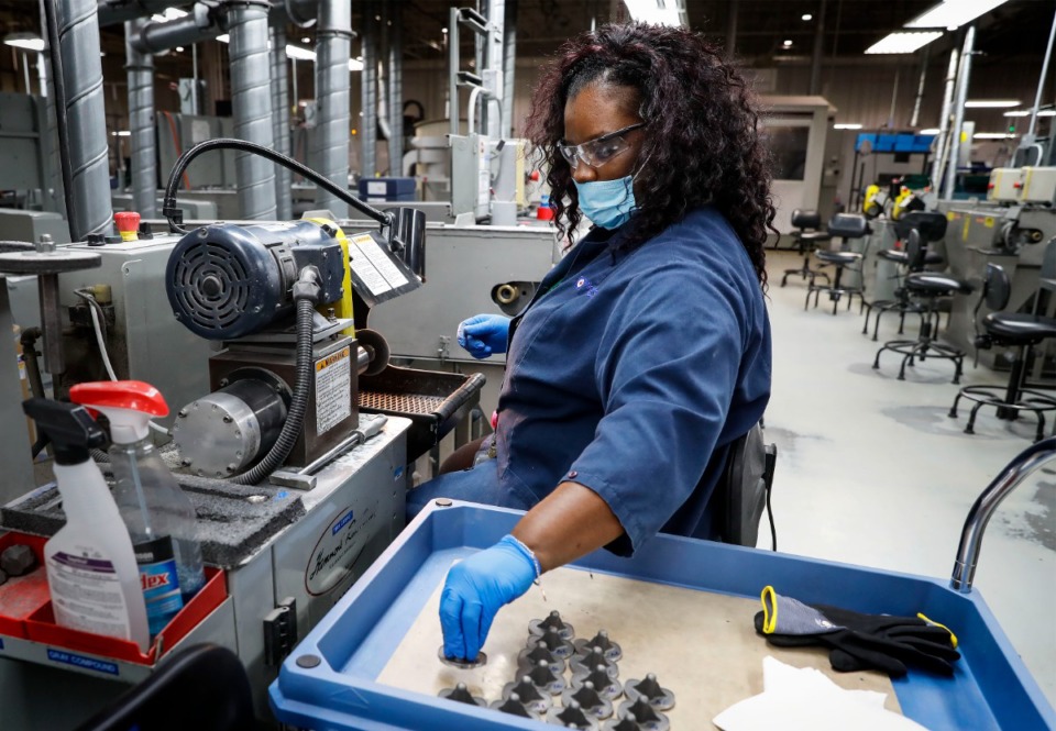 <strong>MicroPort Orthopedics metal finisher Sharonda Holt works hip and knee replacement parts in 2020. A number of medical-device companies are located in Shelby County.</strong> (Mark Weber/The Daily Memphian file)