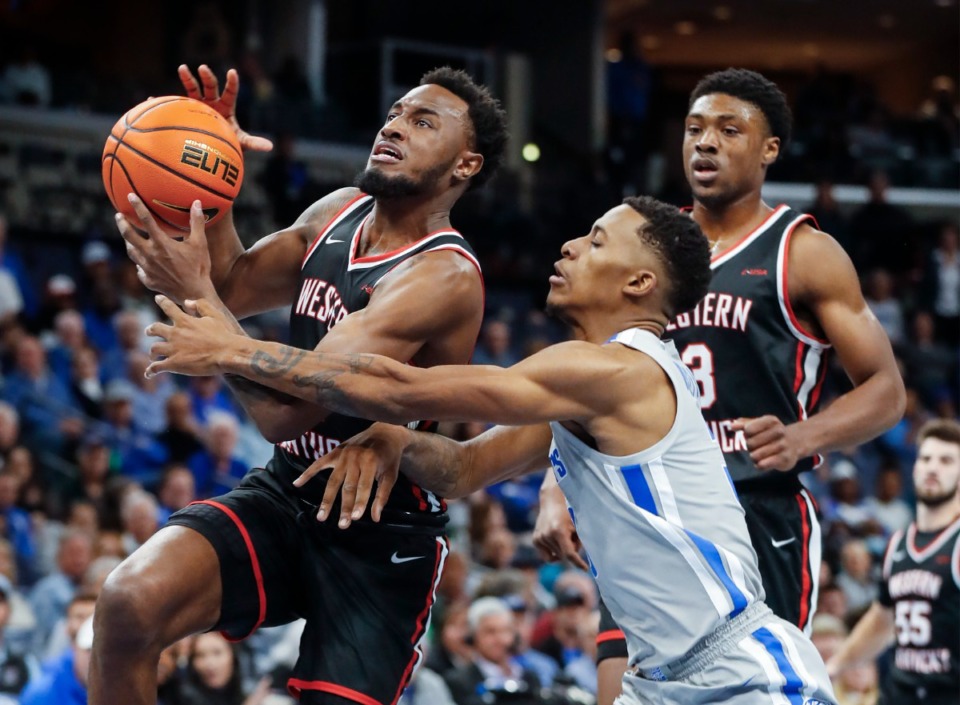 <strong>Tigers defender Landers Nolley II (middle) fouls Western Kentucky guard Josh Anderson (left) on Friday, Nov. 19, 2021.</strong> (Mark Weber/The Daily Memphian)