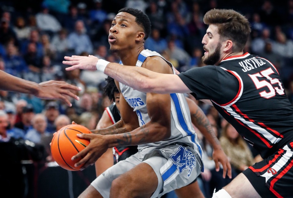 <strong>Tigers guard Landers Nolley II (left) drives the lane against Western Kentucky&rsquo;s Cameron Justice (right) on Friday, Nov. 19, 2021.</strong> (Mark Weber/The Daily Memphian)