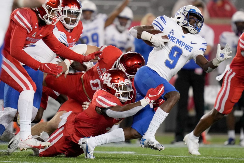 <strong>Memphis running back Gabriel Rogers (9) is tackled by Houston linebacker Donavan Mutin, left,</strong>&nbsp;<strong>on Friday, Nov. 19, 2021, in Houston.</strong> (Eric Christian Smith/AP)