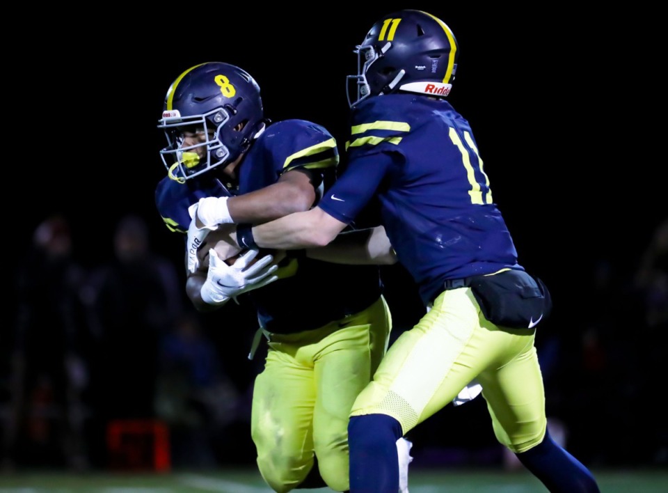 <strong>Lausanne quarterback Brock Glenn (11) hands the ball off to running back Craig Cunningham (8) during the Nov. 19, 2021, home game against CPA.</strong> (Patrick Lantrip/Daily Memphian)