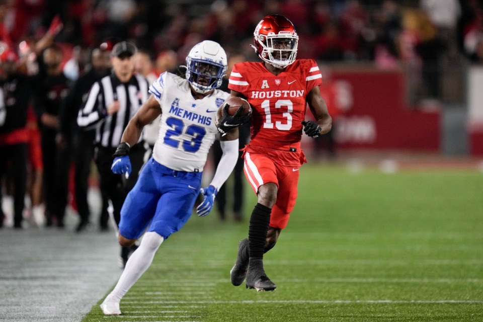 <strong>Houston wide receiver Jeremy Singleton (13) runs past Memphis linebacker JJ Russell (23) after his reception on Friday, Nov. 19, 2021, in Houston.</strong> (Eric Christian Smith/AP)