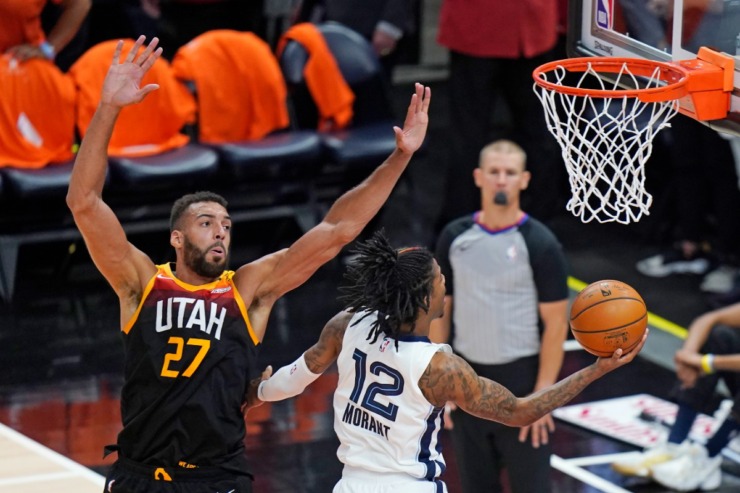 Memphis Grizzlies guard Ja Morant (12) went to the basket as Utah Jazz center Rudy Gobert (27) defended him during Game 5 of the teams&rsquo; NBA first-round playoff series in 2021. (AP Photo/Rick Bowmer)