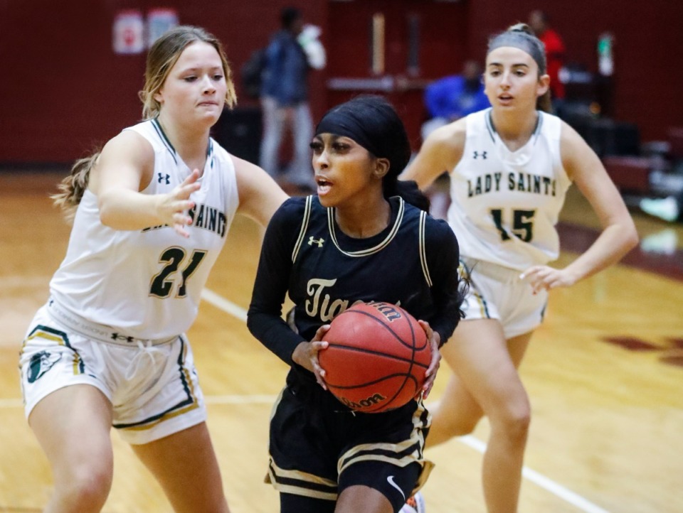 <strong>Whitehaven guard Christal Little (middle) drives the lane against the Briarcrest defense during action of the 50th Martin Luther King Jr., tournament on Monday, Nov. 22, 2021 at Melrose.</strong> (Mark Weber/The Daily Memphian)