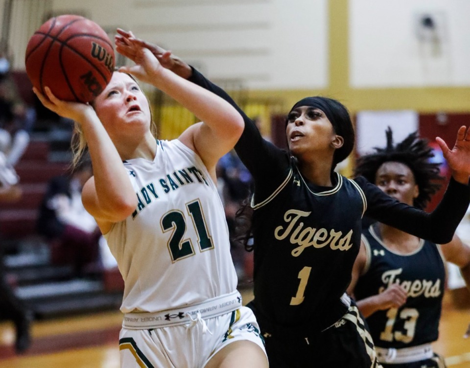 <strong>Briarcrest guard Ella Fite (left) drives to the basket against Whitehaven defender Christal Little (right) during action of the 50th Martin Luther King Jr., tournament on Monday, Nov. 22, 2021 at Melrose.</strong> (Mark Weber/The Daily Memphian)