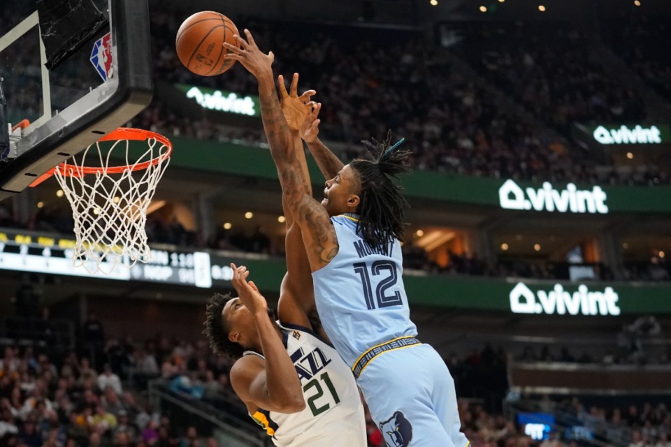 <strong>Memphis Grizzlies guard Ja Morant (12) dunks on Utah Jazz center Hassan Whiteside (21) during the second half of an NBA basketball game Monday, Nov. 22, 2021, in Salt Lake City.</strong> (AP Photo/Rick Bowmer)