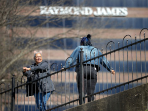 <strong>Tonya Spann (left) takes advantage of the warm spell on Sunday, Feb. 24, to walk through Fourth Bluff park with Kalee Gray across the street from the Raymond James building in Downtown Memphis. The namesake and anchor for the 21-story building, Raymond James &amp; Associates, has plans to move from its office tower to East Memphis&rsquo; Ridgeway Center and enlarge its local workforce there over time.</strong> (Jim Weber/Daily Memphian)