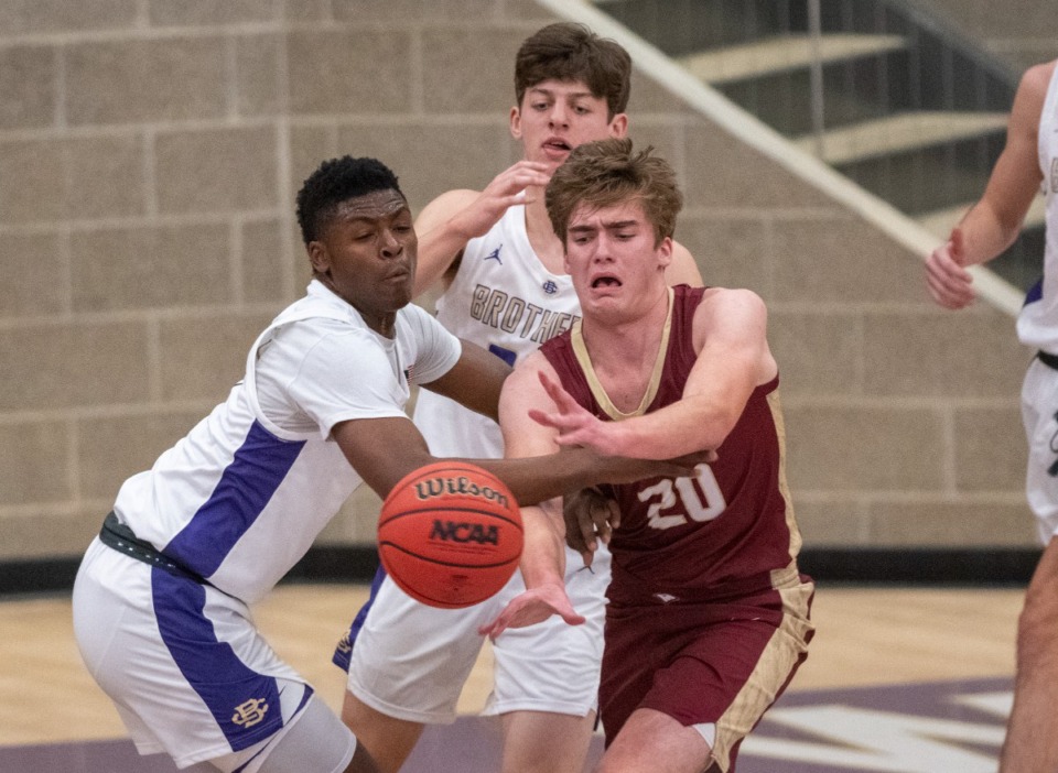 <strong>ECS's William Webster (20) passes the ball as CBHS's Chandler Jackson (1) and Michael Pepper (35) defend in the inaugural game at the new McNeil Family Fieldhouse, Tuesday, Nove. 23, 2021. CBHS defeated ECS 57-25.</strong> (Greg Campbell/Special for The Daily Memphian)