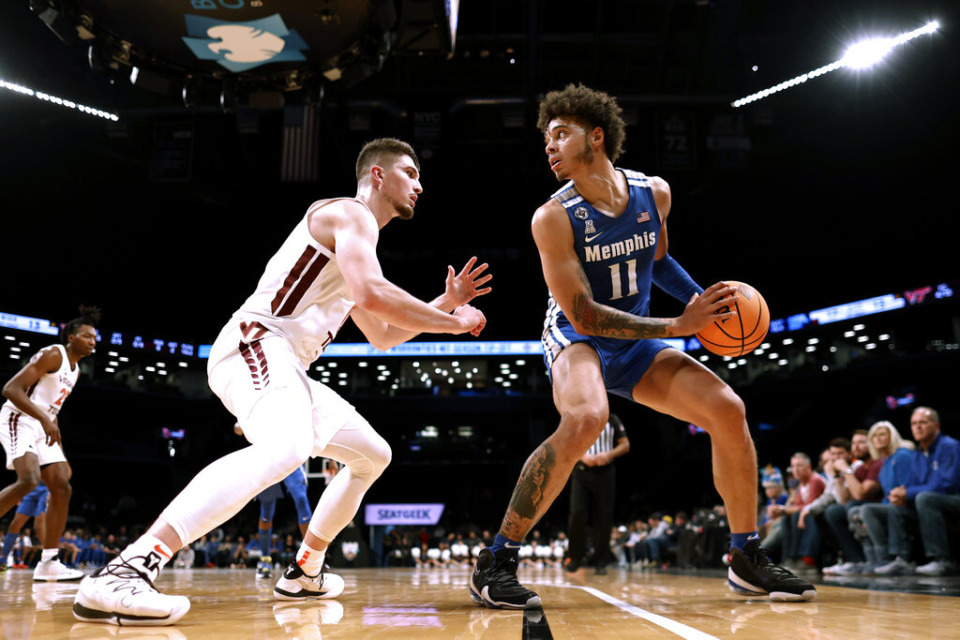 <strong>Memphis' Lester Quinones (11) looks to pass around Virginia Tech's Hunter Cattoor during the first half of an NCAA college basketball game in the NIT Season Tip-Off tournament Wednesday, Nov. 24, 2021, in New York</strong>. (AP Photo/Adam Hunger)