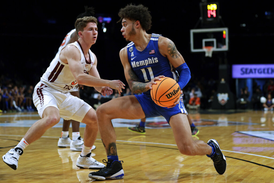 <strong>Memphis' Lester Quinones (11) drives past Virginia Tech's Storm Murphy during the first half of an NCAA college basketball game in the NIT Season Tip-Off tournament Wednesday, Nov. 24, 2021, in New York.</strong> (AP Photo/Adam Hunger)